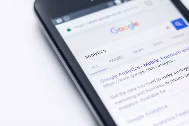 A mobile screen with google analytics search results for SEO audit tools